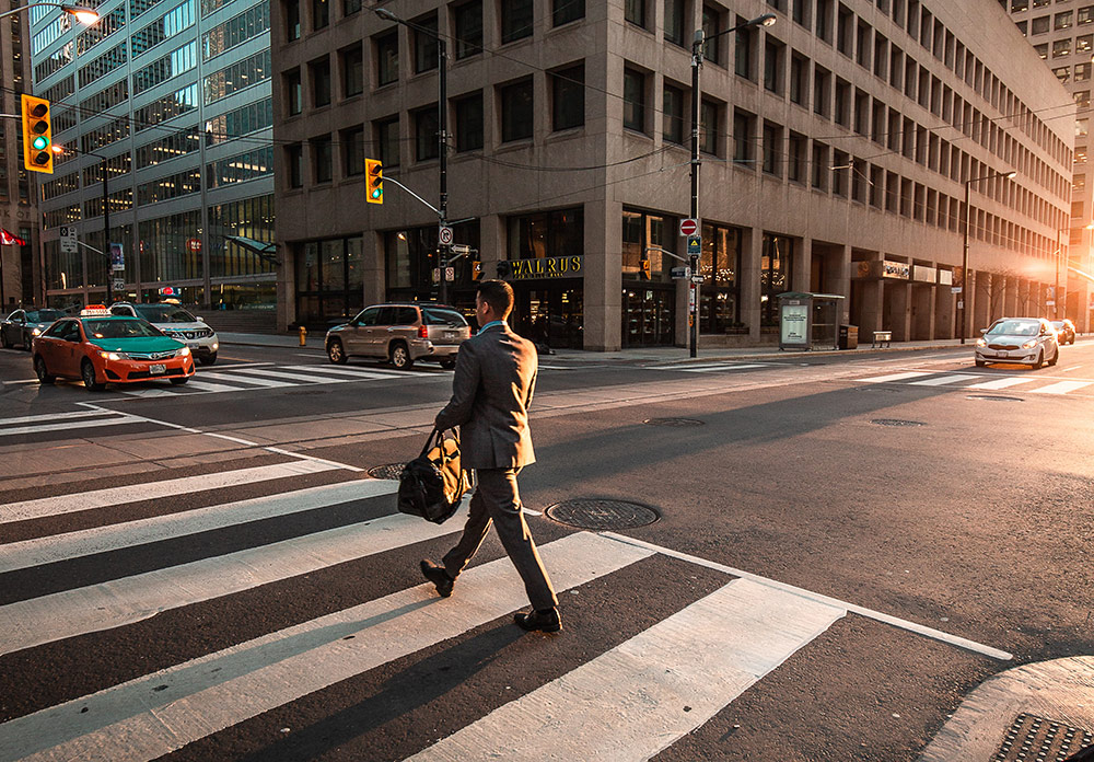 Man Crossing Pedestrian Lane During Office Hours